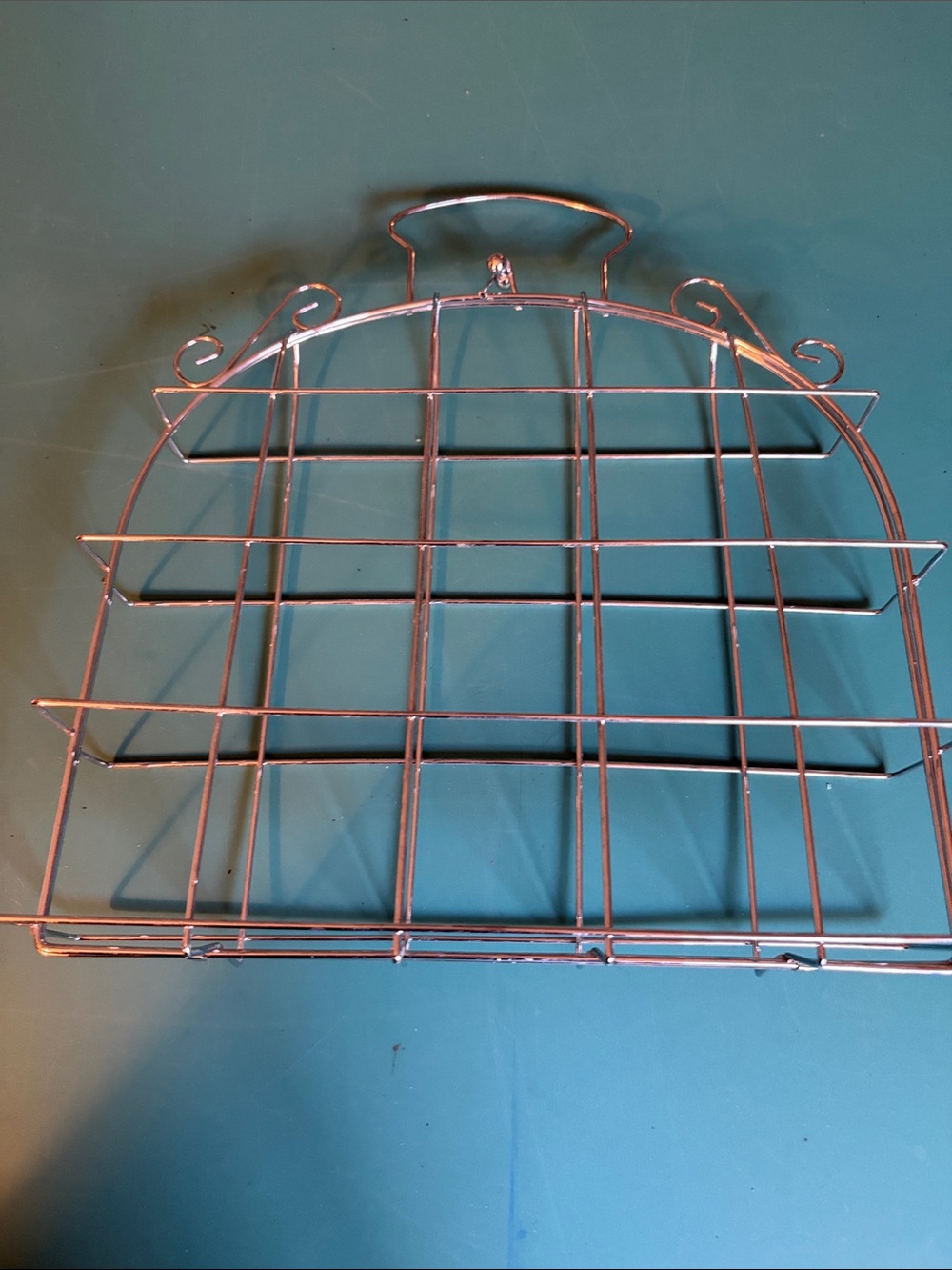 Metal silvertone storage holder with clasp at the top. 12 by 11 inches.